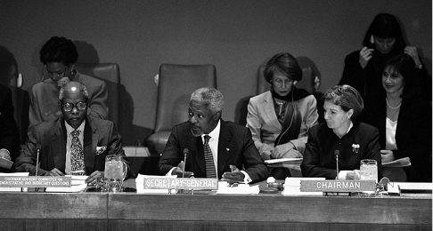 The Australian Permanent Representative to the United Nations, Penny Wensley (right), chairs the UN Fifth Committee as the UN Secretary-General, Kofi Annan (centre), introduces his proposed budget for 2000 to 2001, flanked by the Chairman of the Advisory Committee on Administrative and Budgetary Questions, Conrad Mselle, New York, 27 October 1999. [UN Photo/Eskinder Debebe]