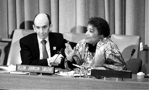 The Australian Permanent Representative to the United Nations, Peter Wilenski (left), participating in the panel discussion organised by the Group on Equal Rights for Women in the United Nations, with Liberian economist (President of Liberia since 2006 and joint awardee Nobel Peace Prize 2011), Ellen Johnson Sirleaf (right), New York, 8 March 1990. [UN Photo/Milton Grant]