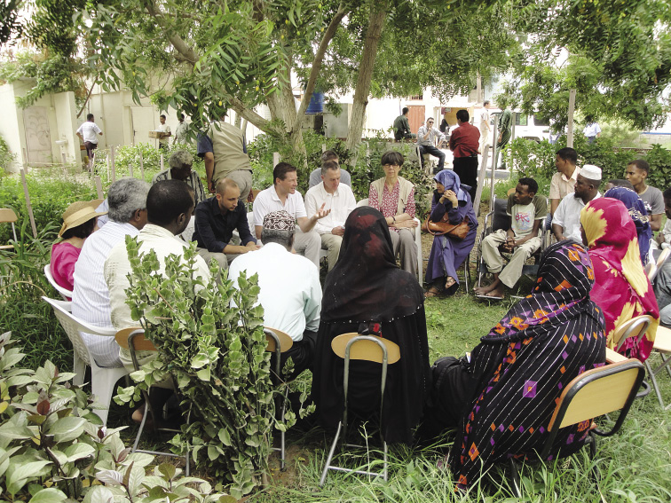 The Australian Permanent Representative to the United Nations at Geneva, Peter Woolcott (centre), speaking with Somali refugee leaders in Bassateen, in his role as Chair of the Office of the UN High Commissioner for Refugees Executive Committee, Yemen, 7 July 2010. [Department of Foreign Affairs and Trade]