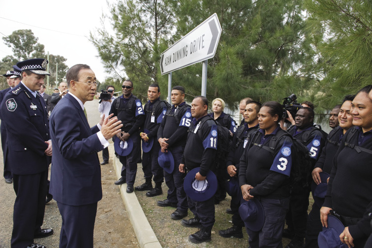 The Australian Federal Police Commissioner, Tony Negus (left), accompanies the Secretary-General, Ban Ki-moon (second left), as he meets police officers from Vanuatu, Kiribati, the Federated States of Micronesia, Nauru, the Marshall Islands and Samoa undertaking UN-recognised pre-deployment training at the Australian Federal Police International Deployment Group Facility, Canberra, 8 September 2011. [UN Photo/Eskinder Debebe]