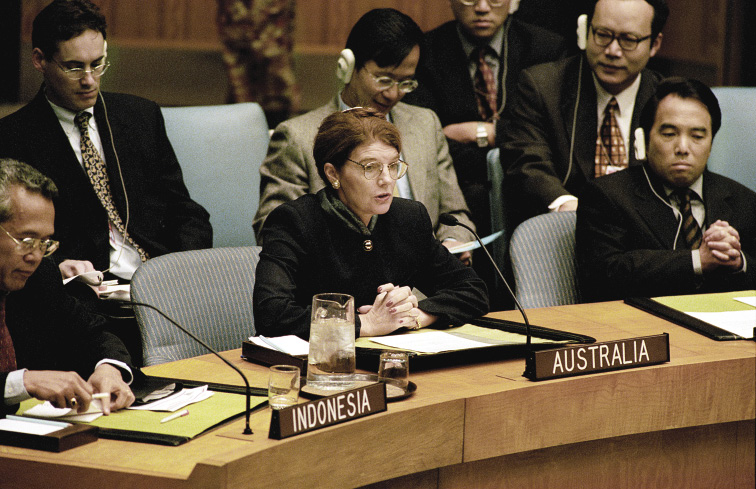 The Australian Permanent Representative to the United Nations, 1997 to 2001, Penny Wensley, accompanied by Counsellor Rod Smith (back left), addressing the Security Council during a meeting in which it unanimously adopted Resolution 1272 (1999), establishing the United Nations Transitional Administration in East Timor (UNTAET) for an initial period up to 31 January 2001, New York, 25 October 1999. [UN Photo/Markisz]