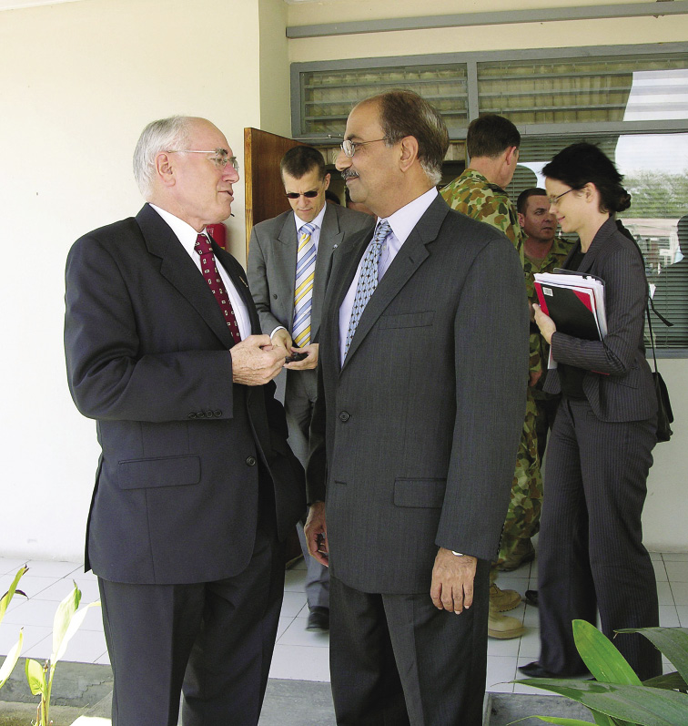 The Australian Prime Minister, John Howard (left), talks with the Deputy Special Representative of the Secretary-General for Timor Leste and acting Officer-in-Charge, Anis Bajwa, during a visit to the UN Office in Timor Leste (UNOTIL), Dili, 18 July 2006. [UN Photo/Laila Shamji]