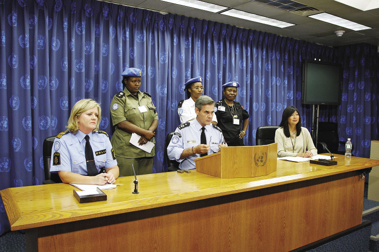 The Australian UN Police Adviser, Andrew Hughes (centre), and the Swedish Deputy UN Police Adviser, Ann-Marie Orier (left), with the Deputy Spokesperson for the Secretary-General, Marie Okabe (right), present initiatives calling for increased representation of female police in peacekeeping operations and encouraging the recruitment of women in national police services, watched by UN Police officers from peacekeeping missions in Liberia (UNMIL), Sudan (UNMIS) and Haiti (MINUSTAH), New York, 7 August 2009. [U