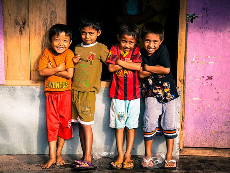 Four boys smiling at the camera.