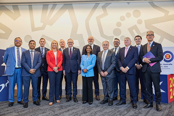 A group of 13 people, including Prime Minister Anthony Albanese, standing together