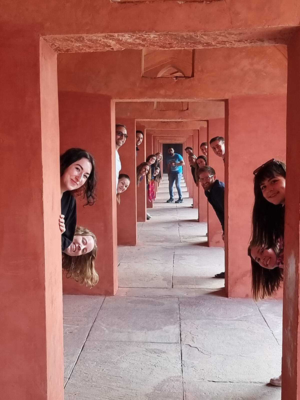 People hiding behind pillars with just their heads showing.