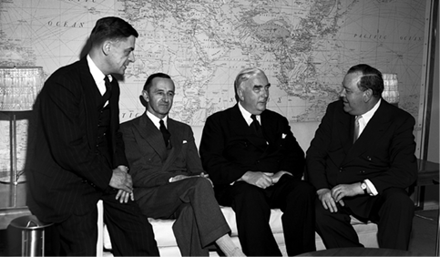 The Australian Prime Minister, Robert Menzies (second right), talks with the UN Secretary-General, Trygve Lie (right), accompanied by the Australian Permanent Representative to the United Nations, WD (Bill) Forsyth (left), and the Secretary of the Department of External Affairs, Alan Watt, during a visit to the United Nations, New York, 22 May 1952. [UN Photo/MB]