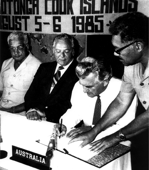 The Australian Prime Minister, RL (Bob) Hawke (seated right), together with the Fijian Prime Minister, Ratu Sir Kamisese Mara (left), and the Cook Islands Prime Minister, Sir Thomas Davis (centre), signing the South Pacific Nuclear Free Zone Treaty (Treaty of Rarotonga), Rarotonga, Cook Islands, 6 August 1965. [Department of Foreign Affairs and Trade]