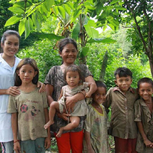 Two adults and five children posing for photo.