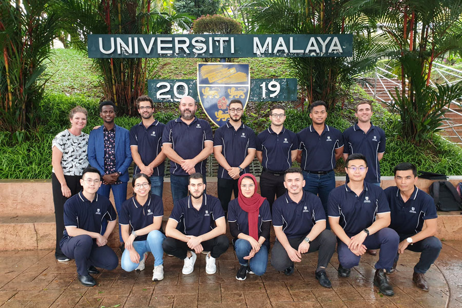 Group photo of students in front of Universiti Malaysia sign. 