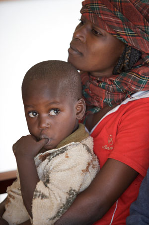 Ugandan mother holding baby.