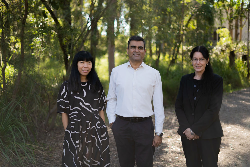 Group photo of Dr Jessica Siva, Associate Professor Thayaparan Gajendran and Dr Kim Maund out bush. 