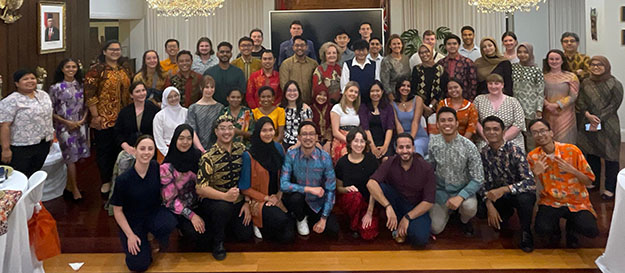 Group of people posing for photo at an event.