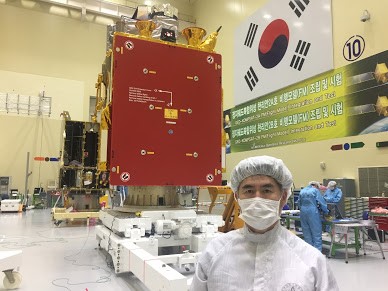 A photo showing a man standing in front of the Korean geostationary satellites, GK2A and GKB before the launch. 