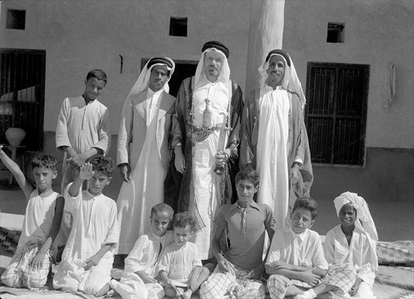 Old Black and White photo of eleven people in Kuwait. 