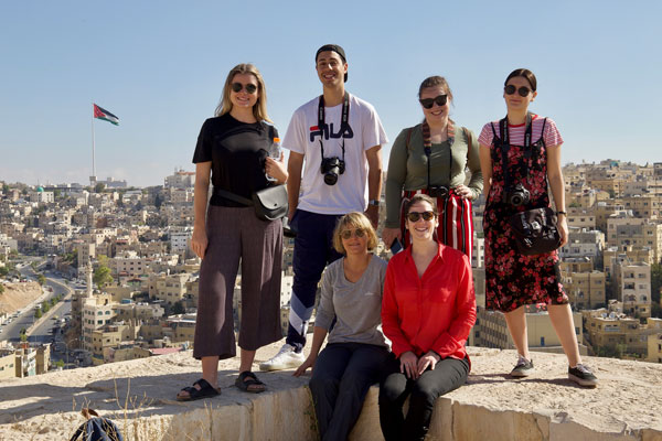 Group of people standing in front of a city