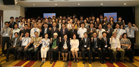 group of people posing for photo in a conference room