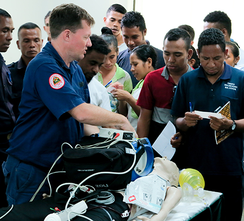 Paramedic working on a dummy in front of students