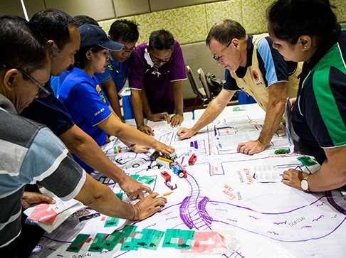 People working on a map of a town or city.