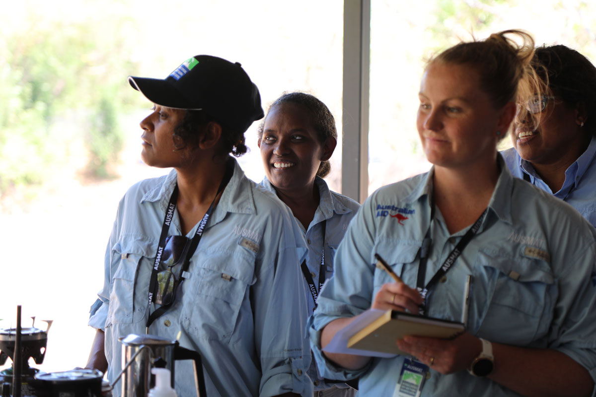 Photo of 4 diverse women during a training seminar for medical professionals.