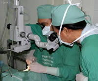 Photo of two medical staff performing surgery