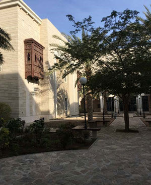 Photo of a courtyard with a building in the background.