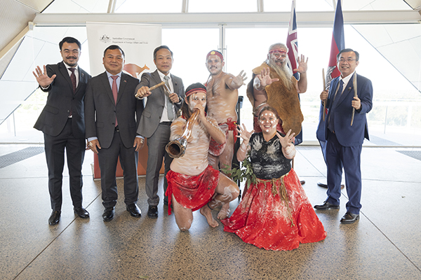 First Nations group in traditional dress – Wiradjuri Echoes – posing with senior Cambodian officials at a reception inside the National Arboretum, Canberra.