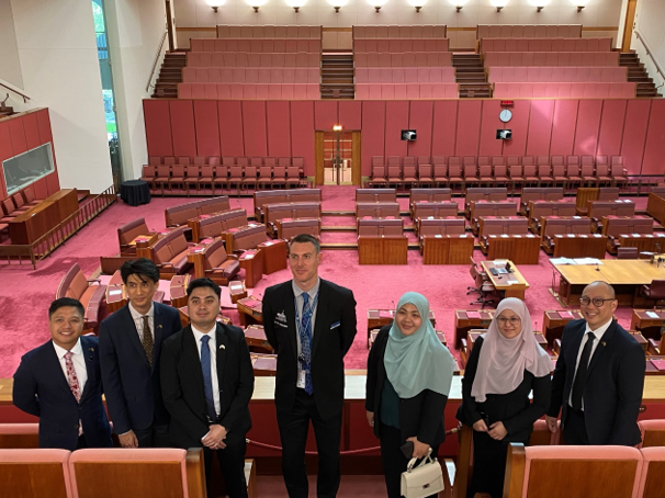 5 men and two women standing in the senate gallery in Parliament House, Australia