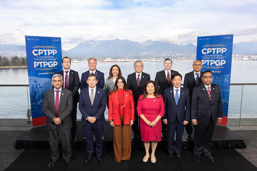 12 CPTPP members, including Australia, standing outside, in front of a lake with mountains in the background, after participating in the Eighth CPTPP Commission meeting in Vancouver, Canada on 28 November 2024