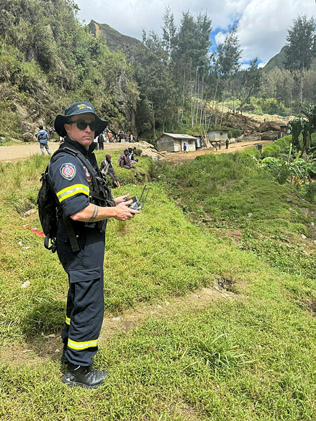 Man in uniform controlling a drone