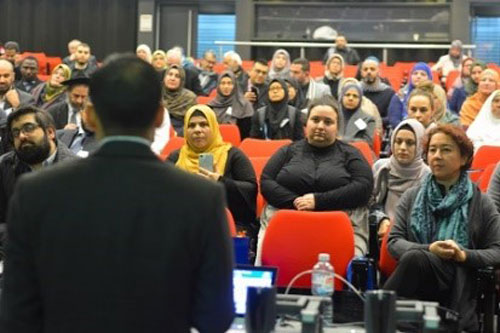 Photo of Dr Nadeem Memon speaking to a crowd of people.