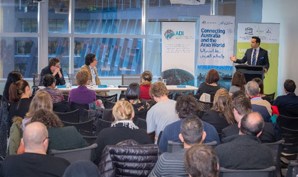 People watching a speaker at a podium