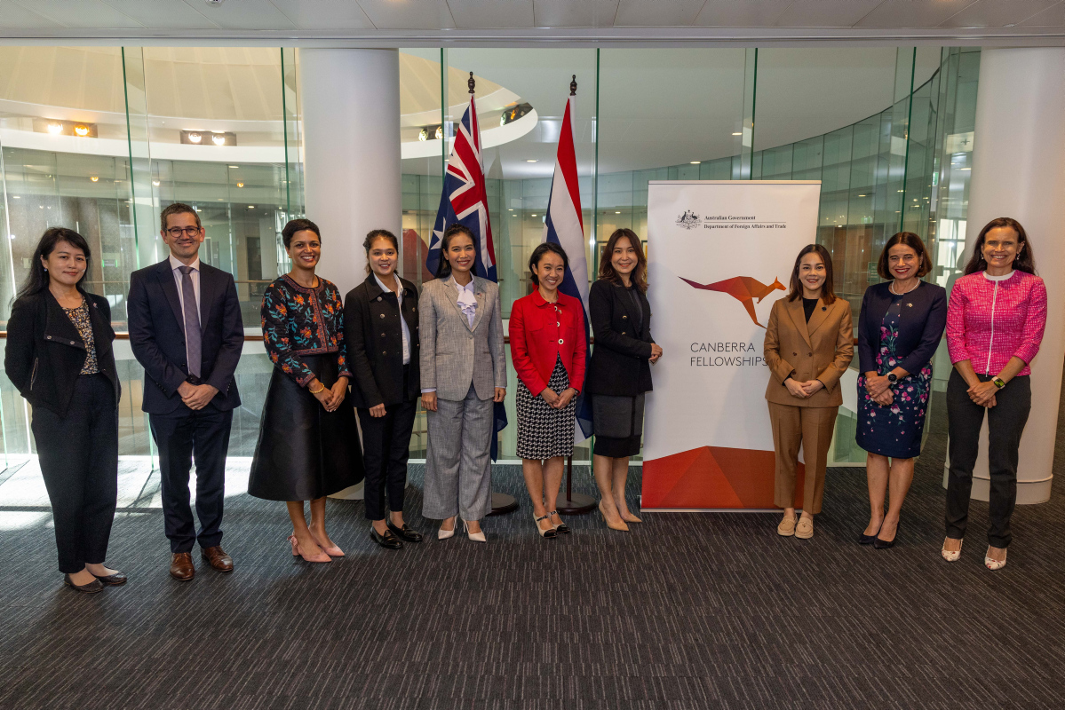 Ten people stand in a row alongside a Canberra Fellowship banner.