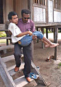 Photo of a man carrying a boy down some stairs