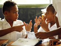 Photo of school children conversing in sign language