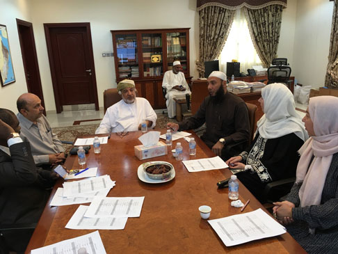 Photo of people sitting around a table in discussion.