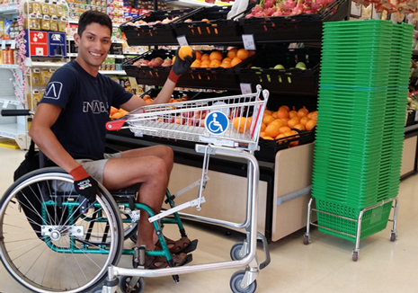 Enabled Future’s student Danny trying out a wheelchair usable shopping trolley in Singapore’s Enabling Village