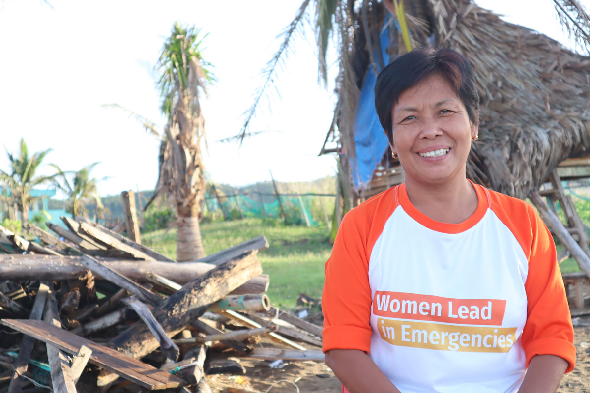 Portrait of Marilou stranding in front of logs