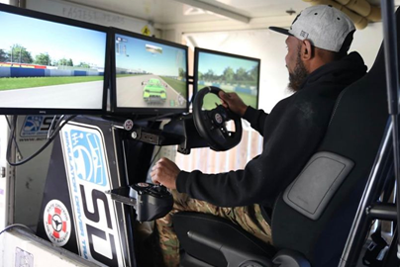 Photo of Ni-Vanuatu David Abel undertaking a safe driver training course in a virtual simulator.