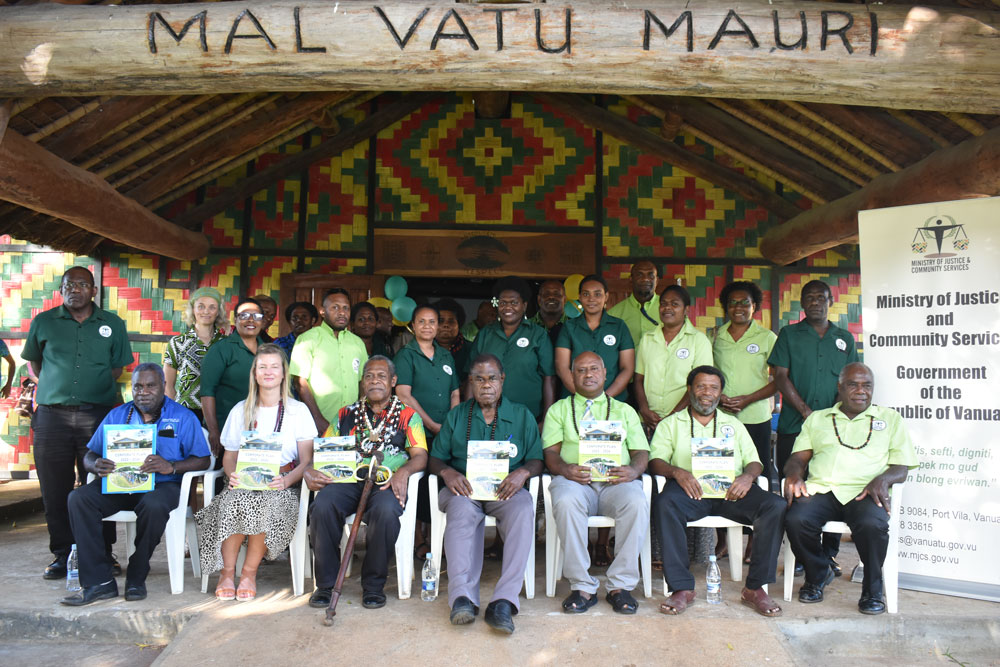 Group photo of participants holding certificates at the Ministry of Justice and Community Services launch event with first Secretary Stephanie Kimber. 