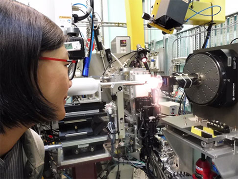 Chinese journalist looking at scientific equiptment.