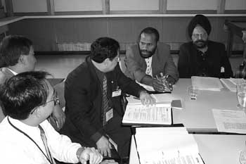 Photo of 5 men holding a discussion at a Regional Workshop.