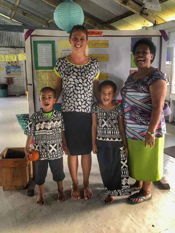 Maxi Jerram-Snell with two kindergarten kids and a teacher in Suva, Fiji.