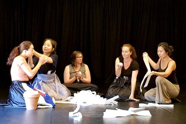 Girls on a stage with props