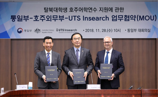 Men holding up document folders