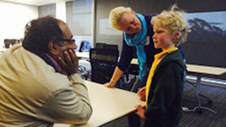 Families who have benefited from Australian cochlear implant technology were invited to share stories with journalists on the G20 IMV. Pictured: Ravi Velloor (Singapore Post) with family members 