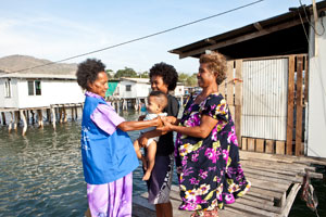 A TB outreach worker visiting a family with a baby