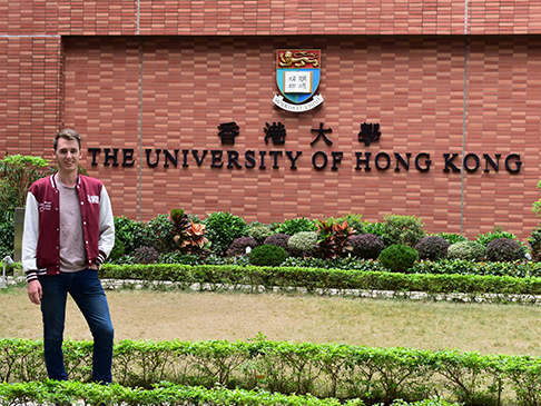 Ryan standing in front of The University of Hong Kong entrance