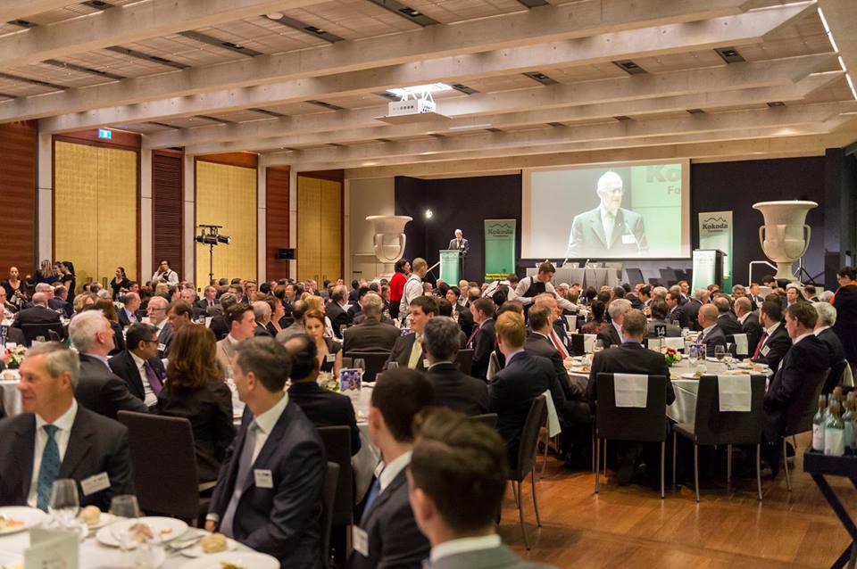 room full of diners sat at round tables