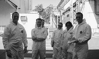 Photo of 6 representatives and inspectors in protective suits.